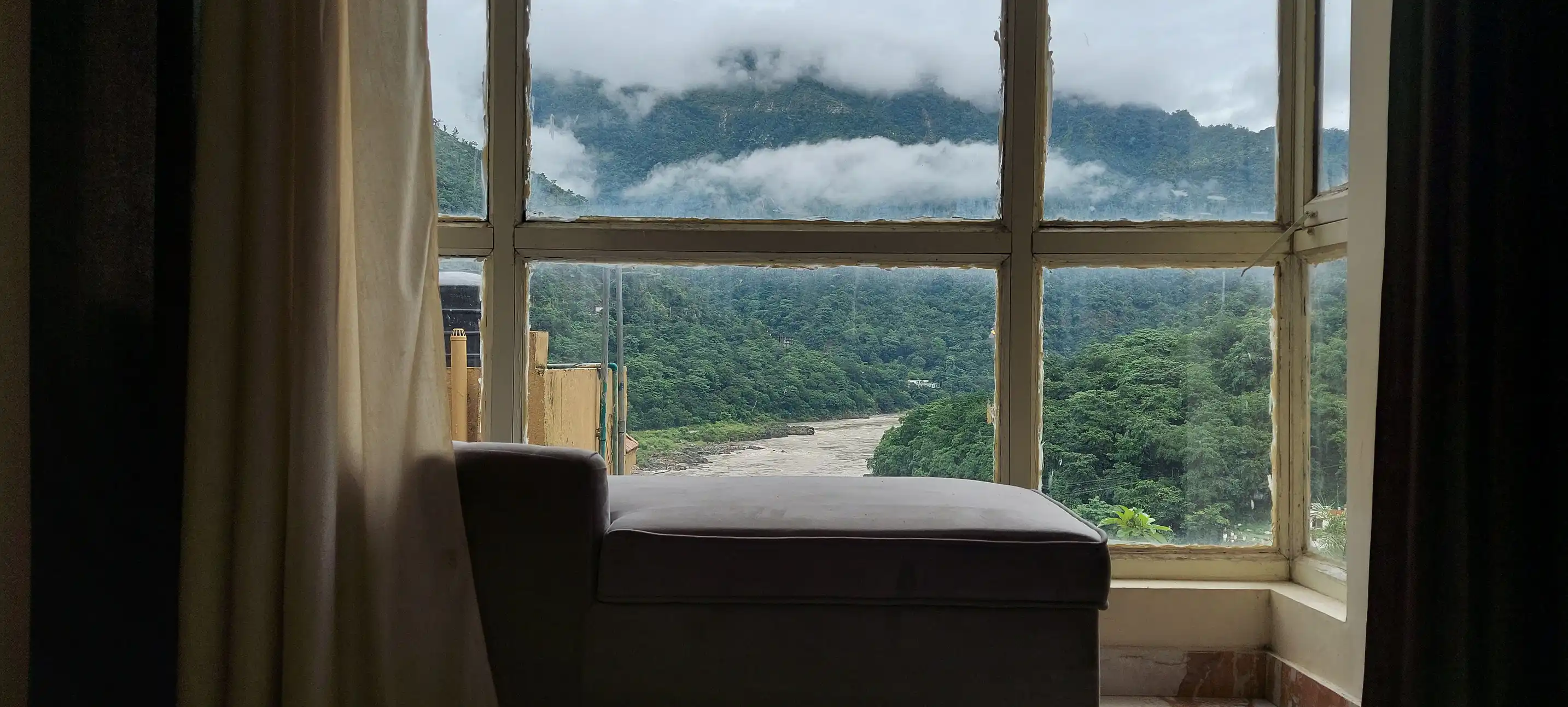 Chaise lounge by the window with mountain view