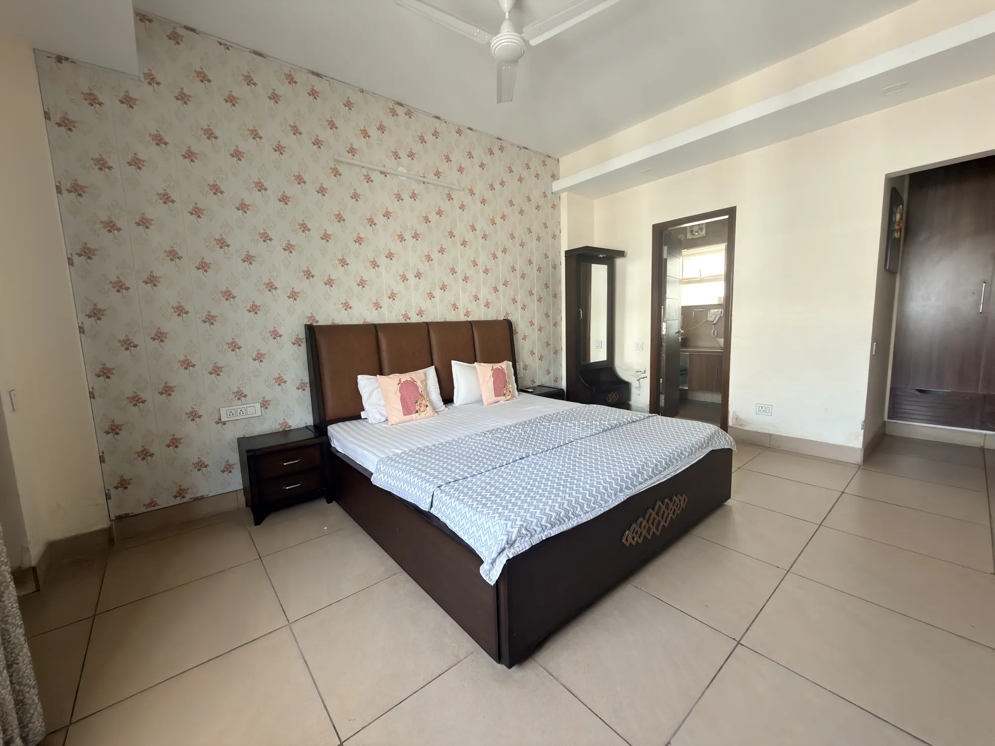 Deluxe bedroom with floral feature wall